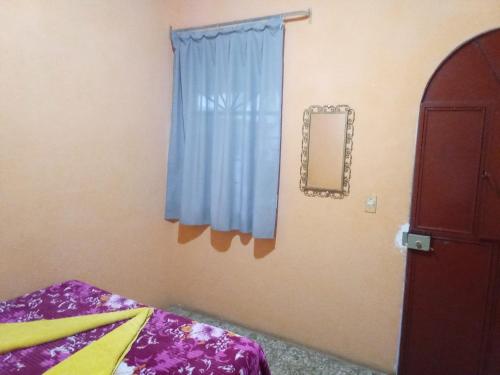 Ένα ή περισσότερα κρεβάτια σε δωμάτιο στο Hospedaje Santo Domingo