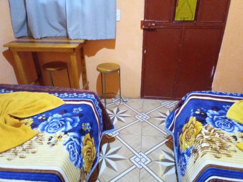 Ένα ή περισσότερα κρεβάτια σε δωμάτιο στο Hospedaje Santo Domingo