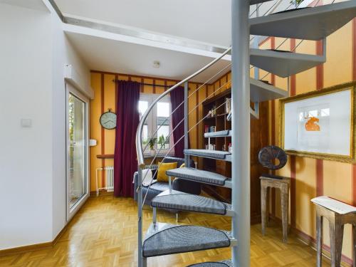 a spiral staircase in a room with orange walls at große, elegante Ferienwohnung in Langenfeld