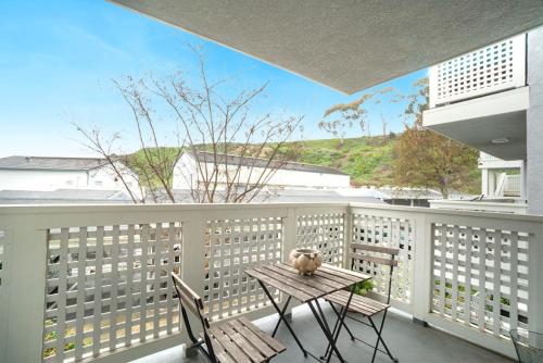 a patio with a table and chairs on a balcony at Beach Condo in Dana Point