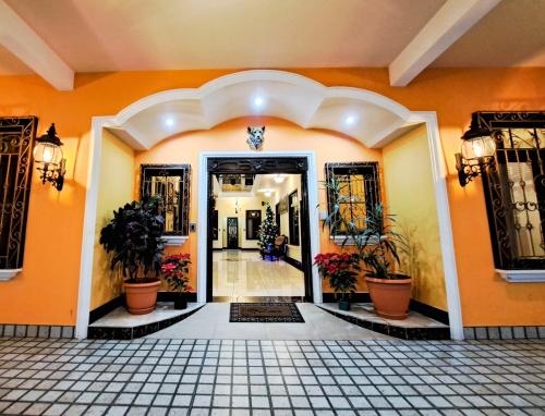 an entrance to a building with plants on the walls at La Mansión del Gran Jaguar in Retalhuleu