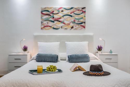 a bedroom with a bed with a tray of food on it at Precioso apartamento en el centro de Las Américas a 100 metros de la playa in Playa de las Americas