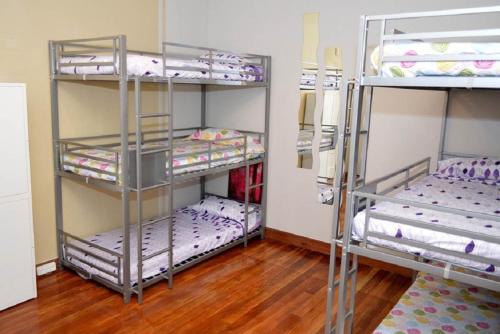two bunk beds in a room with wooden floors at Hostel Santander in Santander