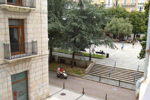 a person riding a motorcycle on a city street at Hostel Santander in Santander