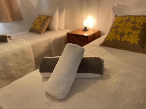 a rolled up towel on a bed in a hotel room at Ananahi plage in Paea