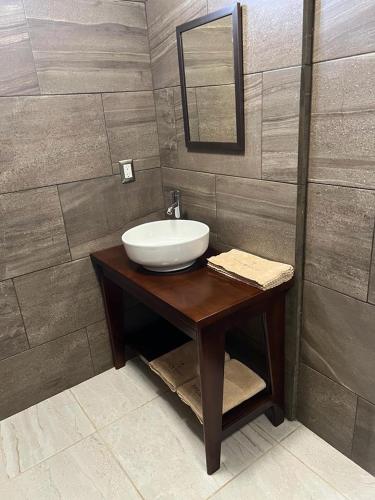 a bathroom with a sink and a mirror at Kasa Morelos Hotel Boutique in Concordia