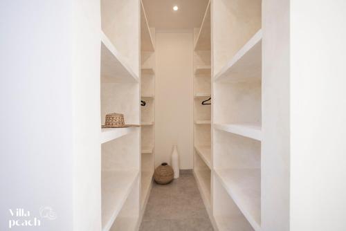 a hallway with white shelves in a house at Beach Villas Canggu 300m from Echo Beach in Canggu