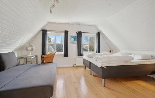 two beds in a room with two windows at Gorgeous Home In Otterup With Kitchen in Otterup