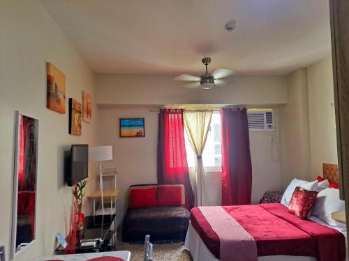 a bedroom with a red bed and a chair at Amaia Steps Altaraza by Gem in San Jose del Monte