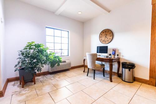 an office with a desk and a clock on the wall at Grand Hotel in Spring City
