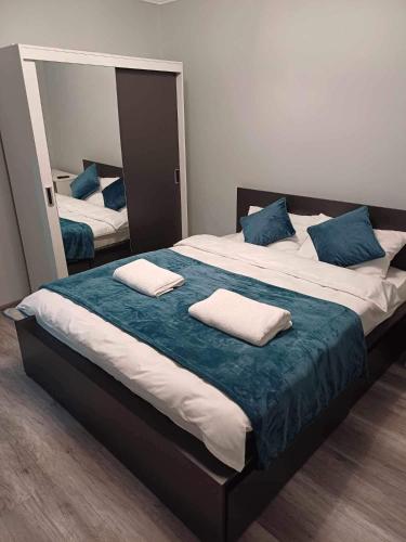 a large bed with two pillows on top of it at Pleasure Palace in Sovata