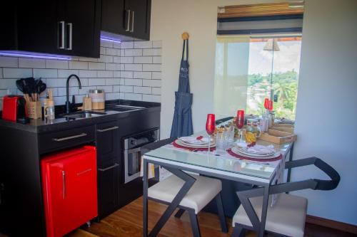 a kitchen with a table with plates and glasses on it at T24 Tinyhouse Container in Ibiúna