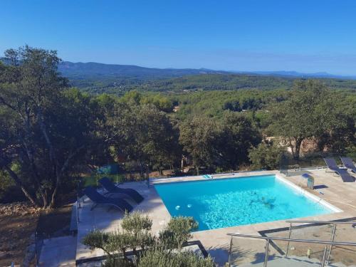 une grande piscine avec des chaises et des arbres dans l'établissement Villa in Lorgues with Private Pool, à Lorgues