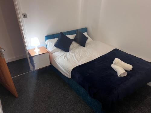 a bedroom with a bed with two towels on it at Central 4 bedroom house in the heart of Birmingham city with Free Parking, and sleeps up to 8! in Birmingham