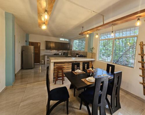 a kitchen and dining room with a table and chairs at Lovely Inn in San Cristóbal