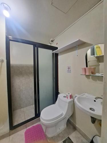 a bathroom with a toilet and a sink at Amaia Steps Altaraza by Gem in San Jose del Monte