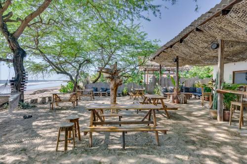 a group of picnic tables and chairs under a umbrella at Popoyo Republic in Popoyo