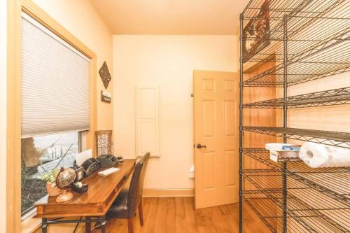 a dining room with a table and a shelf at Colibri Cabin on a peaceful lake, with a hot tub! in East Bernstadt