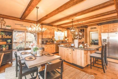 a kitchen with a table and chairs and a refrigerator at Colibri Cabin on a peaceful lake, with a hot tub! in East Bernstadt