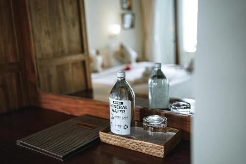 a bottle of vodka sitting on a table at Amed Cafe & Hotel Kebun Wayan in Amed