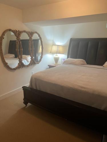 a bedroom with a large bed and a mirror at Atkins Investments Inc. Swanhaven in Richmond