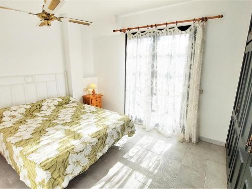 1 dormitorio con cama y ventana en Apartamento Llançà, 2 dormitorios, 5 personas - ES-170-41, en Llançà