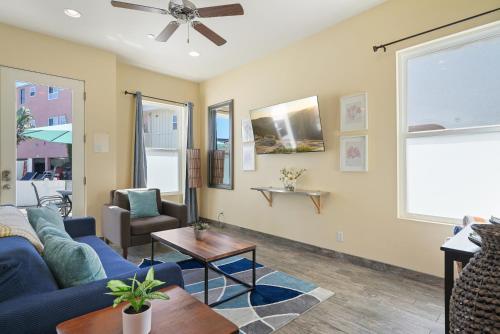 a living room with a blue couch and a table at Mission Paradise - Spa, Pet Friendly, Steps2Sand in San Diego