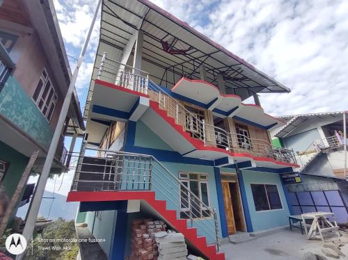 a building with a staircase on the side of it at KACEY HOMESTAY in Pedong