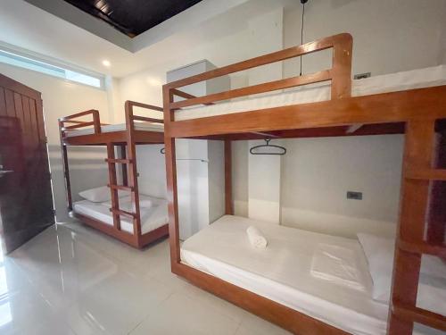 two bunk beds in a room with a window at Koze Suites in Dumaguete