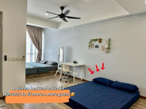 a bedroom with a blue bed and a desk at Designer Muji Penthouse Johor Bahru/Paradigm in Johor Bahru