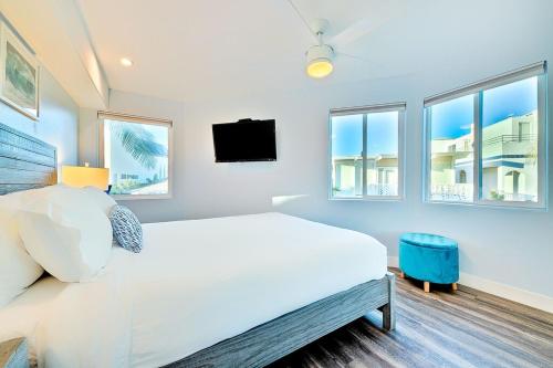 a white bedroom with a large bed and windows at Stunning South Mission Home with Private Rooftop & Ocean Views! in San Diego