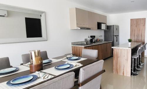 a kitchen with a table with blue plates on it at Torre Alba 103 in Mazatlán