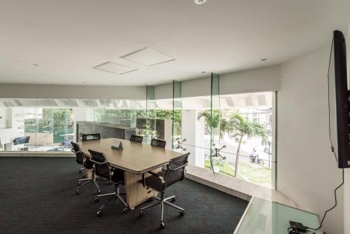 an office with a conference room with a table and chairs at Naki Suites @ Silvertown in Phnom Penh