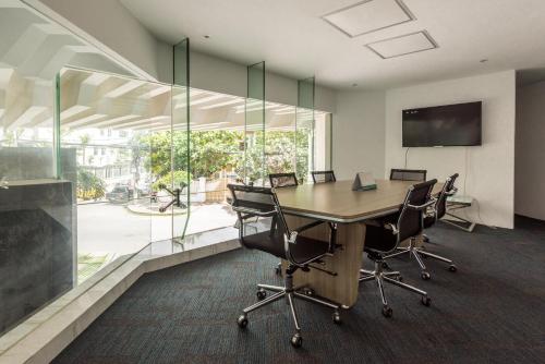 an office with a conference room with a table and chairs at Naki Suites @ Silvertown in Phnom Penh