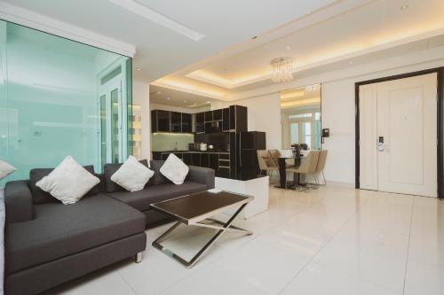 a living room with a couch and a table at Naki Suites @ Silvertown in Phnom Penh