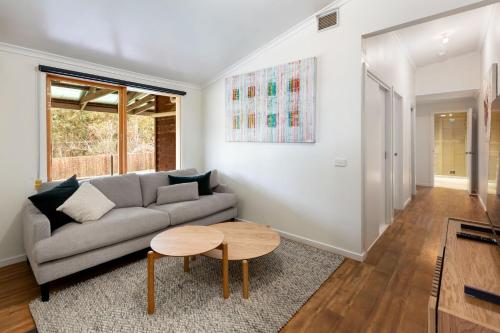 a living room with a couch and a table at Mansfield Hideaway - Sleeps 10 in Mansfield