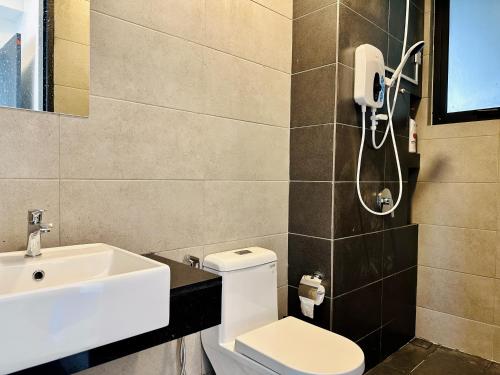 a bathroom with a toilet and a sink at New 2BR or 3BR Cozy Urban Suite Homestay at Georgetown8-10pax by URBAN STAYCATIONS LOD in Jelutong