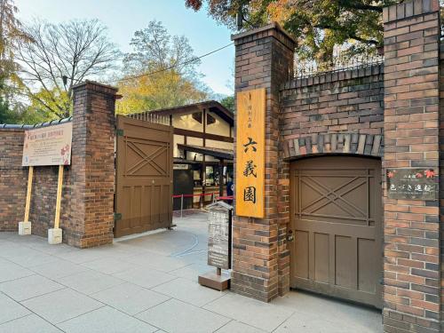 a brick building with two garage doors with writing on it at 3 min to Komagome Sta by foot/15min to Shinju&Tokyo Sta by JR in Tokyo