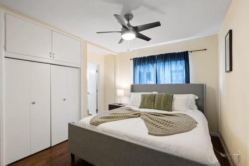 a bedroom with a bed with a ceiling fan at Pacific Oasis - Large Patio, Parking & Walk to Beach in San Diego