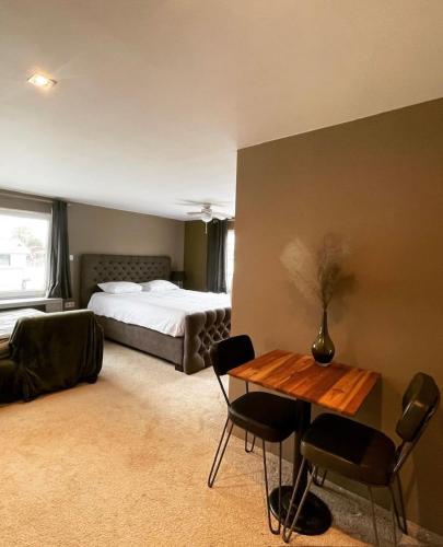 a bedroom with a bed and a table and chairs at Amster Houseboat in Amsterdam