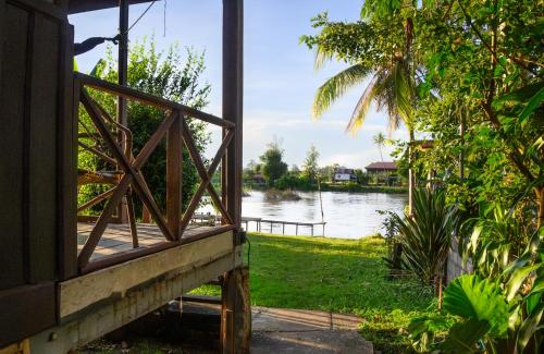 a window of a house with a view of a river at Lao Long Riverside and Budget Garden Guesthouse in Ban Khon