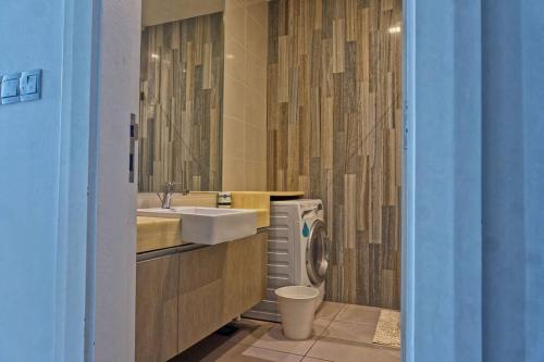 La salle de bains est pourvue d'un lavabo et de toilettes. dans l'établissement Studio Apartment @ M-City, Jalan Ampang with Lake View, à Kuala Lumpur