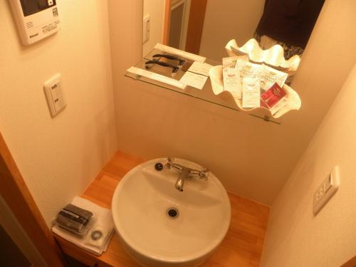 a small bathroom with a sink and a mirror at B&BHOUSE FAM - Vacation STAY 39468v in Ichinomiya