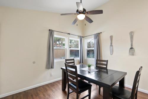 a dining room with a table and chairs and a ceiling fan at Pacific Paradise - Large Patio, Hot Tub, Short Walk to Beach, & Parking in San Diego