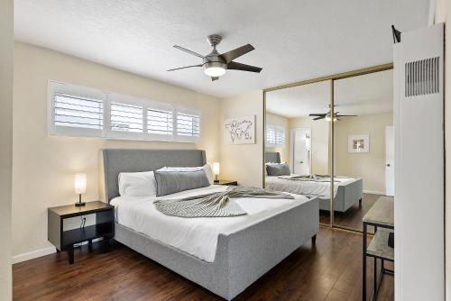 a bedroom with a bed and a ceiling fan at Pacific Paradise - Large Patio, Hot Tub, Short Walk to Beach, & Parking in San Diego