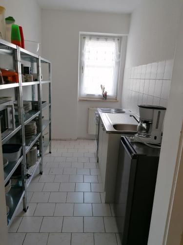 uma pequena cozinha com um lavatório e um fogão em Monteurwohnung App. 10 em Pirmasens