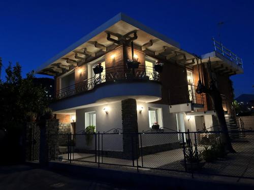 a large house with a balcony at night at Villa Gerani in Bordighera