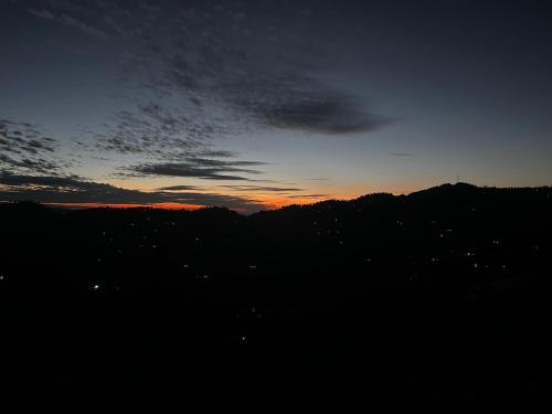 a view of a sunset with the sky at EcoEscape Mukteshwar in Mukteswar