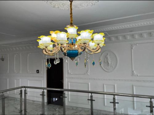 a chandelier hanging from a ceiling in a room at The Peacock Mansion in Kumasi