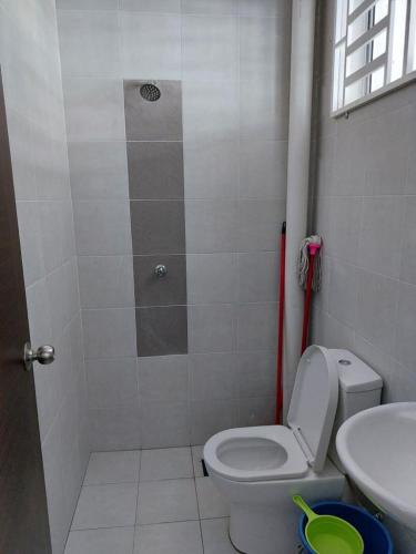 a bathroom with a toilet and a sink at Homestay Taman Kota Emas 
